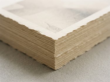 Minimalist editorial photography of a printed capability deck on textured warm paper, soft diffused natural daylight, neutral gray background, 50mm lens