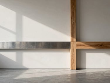 Interior of a modern minimalist workspace, empty space showing natural diffused light patterns on a light plaster wall, brushed steel and oak wood junction detail.