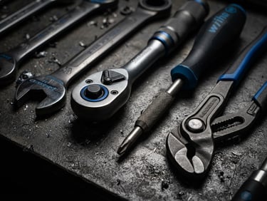 Industrial photography of premium German hand tools arranged on a dark graphite surface, dramatic high-contrast studio lighting, electric blue accents, sharp macro details, 50mm