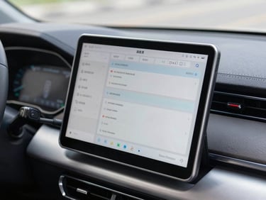 Close-up of a modern diagnostic tablet plugged into a car dashboard, displaying technical data, bright natural daylight, high-contrast industrial tones.