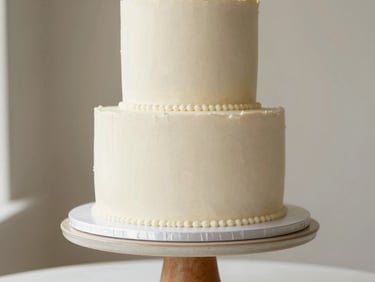 Elegant eye-level portrait of a three-tiered wedding cake on a ceramic pedestal, minimalist styling, soft natural daylight, 35mm