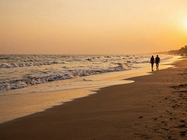 Wide landscape of Digha beach at sunset, gentle waves on dark sand, a couple walking in the distance, warm golden-hour light, professional editorial composition