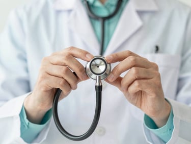 A professional close-up of a doctor's hands holding a stethoscope against a clean, soft mint background, professional medical photography.