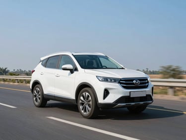 A clean white SUV driving on a modern Indian highway under clear blue skies, crisp commercial tone.