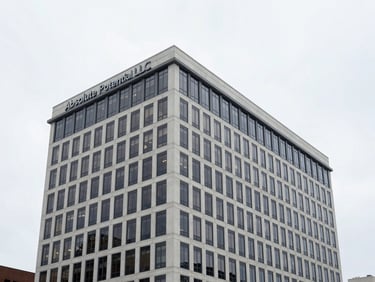 Modern office building in Charlottesville, Virginia, with Absolute Potential LLC branding, clean overcast daylight, 35mm architectural lens