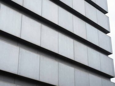 Close-up of modern architectural facade details, sharp contrast, cool desaturated tones, industrial photography style.