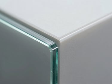 Extreme close-up macro shot of a waterjet-cut laminated glass edge and adjacent polycarbonate sheet, showing clean separation line and zero chipping, bright flat studio tungsten lighting, transparent layers visible in cross-section