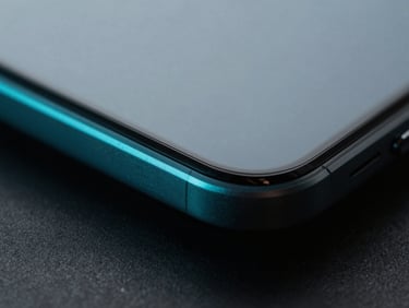 Extreme close-up macro shot of a premium titanium phone edge, sharp directional cool cyan accent light, deep shadows, 35mm