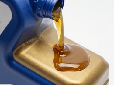 Macro close-up of golden automotive engine oil pouring smoothly, high viscosity, crisp studio light, glossy reflections.
