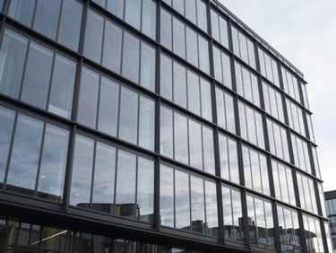 Multi-story glass façade on a contemporary commercial building, structural glazing