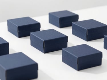 Minimalist premium workspace with structured navy packaging boxes, soft natural morning light, clean shadows, high-key studio setting