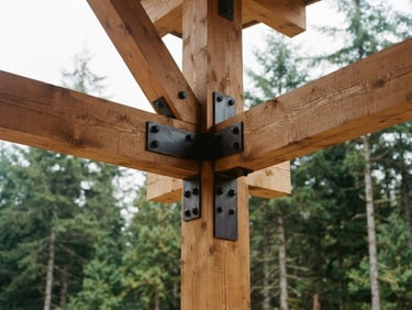 Warm editorial architectural close-up of heavy timber framing with custom steel connection plates, soft overcast daylight, forest green pines in background, 35mm