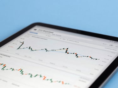 Close-up of a digital tablet displaying financial charts and spreadsheets under crisp office lighting