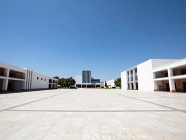 Wide environmental shot of a modern civic plaza in Aguascalientes under a clear blue sky