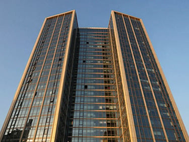Symmetrical modern office tower facade in Gurgaon, glass and steel, sharp angles, crisp golden hour lighting