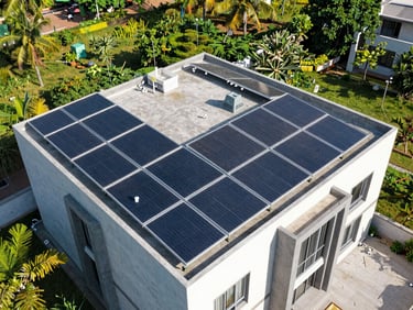 Wide aerial drone shot of a modern Hyderabad villa rooftop with neatly aligned tier-1 solar panels gleaming in bright direct Indian sunlight, sharp focus, architectural perspective