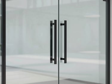Minimalist commercial glass door with sleek black hardware, clean reflections of a modern office lobby, sharp focus on the seamless joint, 35mm
