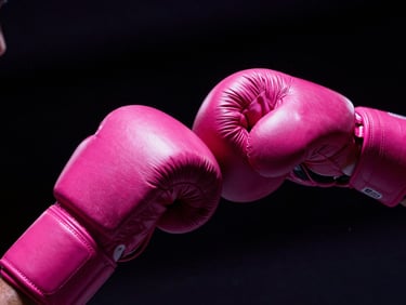 Close-up of wrapped hands of a fighter, high-contrast dramatic lighting, deep shadows, fuchsia tones, 35mm
