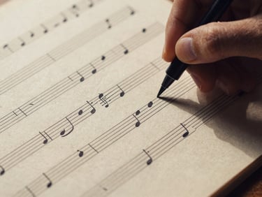 Macro shot of a hand-inked musical manuscript score on aged paper, high-contrast side-lighting, dramatic shadows, warm ivory tones, shallow depth of field, 35mm.