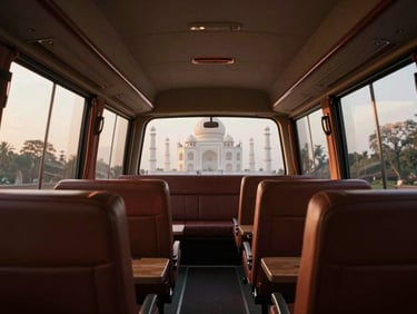 An elegant, modern luxury traveler coach interior, spacious seating layout, clean windows showing a soft-focus view of the Taj Mahal in the distance.