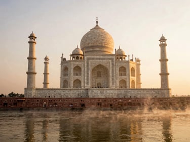 A wide environmental shot of the Taj Mahal at sunrise, soft morning mist rising from the Yamuna River, golden-hour light reflecting on white marble, warm heritage tones, 35mm film look.