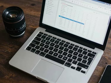Overhead flat-lay of workspace essentials, a sleek laptop showing clean financial UI, natural cool-toned lighting, sharp focus