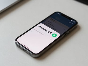 Overhead flatlay of a phone screen displaying a payment notification with a dollar amount, placed on a plain light desk, daylight-neutral, no hands visible
