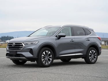 Three-quarter view of a clean grey SUV parked on an asphalt lot, overcast Idaho sky, crisp details.