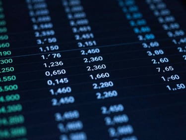 Macro close-up of a financial dashboard with automated ledger entries, dark-toned editorial photography, cool low-key ambient lighting, sharp electric blue highlights, high-contrast, shallow depth of field, 35mm