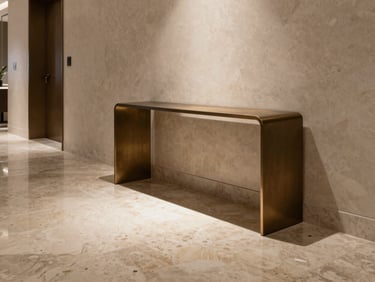 High-end apartment foyer with polished travertine floors, minimal bronze console table, single spotlight highlighting texture.