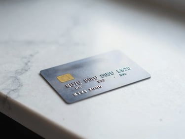 Close-up of a physical credit card resting on a clean marble counter under bright natural daylight.