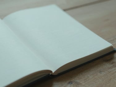 An open journal with clean handwriting on a wooden surface, diffused morning daylight, muted teal tones, 35mm