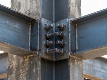 Professional architectural photography, sharp close-up of structural steel connection plates secured with heavy bolts, concrete column background, bright daylight, industrial realism.