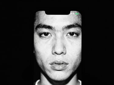 High contrast close-up of a glowing smartphone screen reflecting on a face in a dark room, gritty 35mm film grain.
