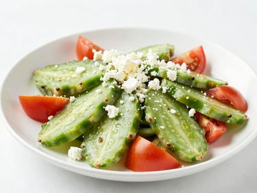 A light salad with sliced green nopales, red tomatoes, and white cheese crumbled on top, bright high-key lighting.