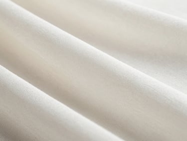 Macro close-up of pristine white Turkish organza fabric, showing fine weave and subtle sheen, soft side-lit daylight