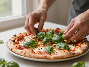 Close-up of hands arranging fresh basil on a gourmet pizza, soft window light, warm editorial photography, shallow depth of field