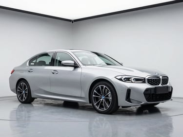 Sleek modern silver BMW sedan parked in a bright minimalist dealership bay, cool metallic tones, 50mm lens