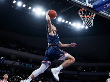 Dynamic motion freeze of a basketball player driving to the hoop, high-contrast stadium floodlight, sharp shadows, 85mm lens.