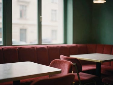 Cozy Scandinavian-style restaurant interior, empty tables, soft window light, warm indoor glow, rich crimson and forest green tones, 35mm film.