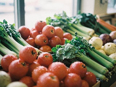 Vibrant display of fresh produce at a modern food market, natural light, rich textures, shallow depth of field, warm editorial photography, 35mm film.