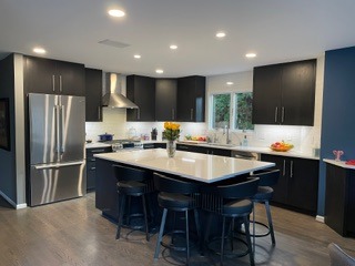 Custom upper and lower kitchen cabinets and island designed and built by Pearce Woodworks Detroit. 