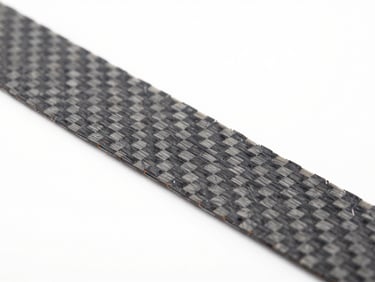 Macro shot of carbon fiber composite filament texture, showing individual micro-fibers, bright high-key lighting, clean white background