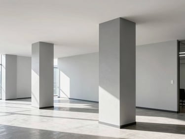 Wide bright completed commercial office interior flooded with natural light, showcasing smooth non-streaky grey paint textures on structural columns