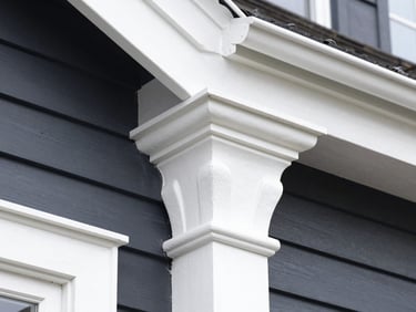 Crisp close-up of razor-sharp paint edges on white Victorian timber trim against deep charcoal weatherboards, bright natural daylight, sharp focus