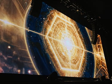 Massive LED screen wall displaying high-resolution colorful graphics on a concert stage, sharp pixel detail, cinematic angle