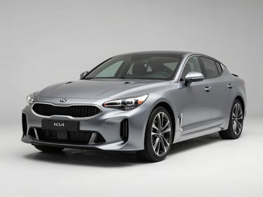 KIA Stinger sedan photographed in three-quarter front view under clean studio strobes on white floor, sharp metallic paint detail, no background distractions