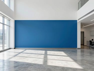 Bright high-key interior photography of an immaculate, modern office lobby, polished concrete floor reflecting natural daylight, minimalist blue accent wall, sharp architectural focus.