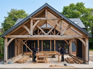 Straight-on architectural photograph of a modern residential framed structure under clean daylight, showing precise timber joinery and organized workspace.