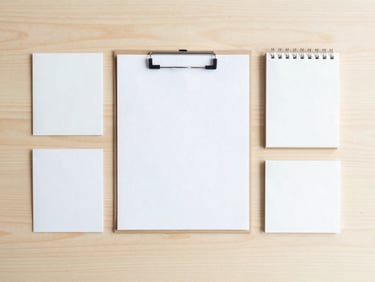 Precise top-down flat lay of organized stationery on a light wood desk, bright morning light, clean minimalist styling
